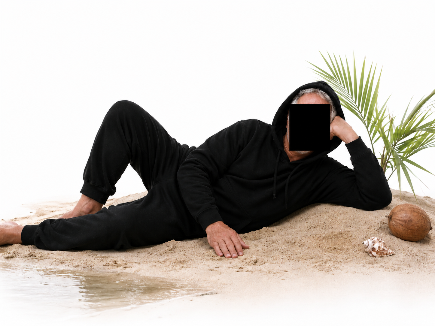 Hoodstein reclining on tropical sand beside a palm frond and coconut